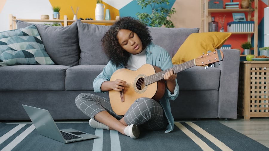 A young woman playing guitar in her apartment